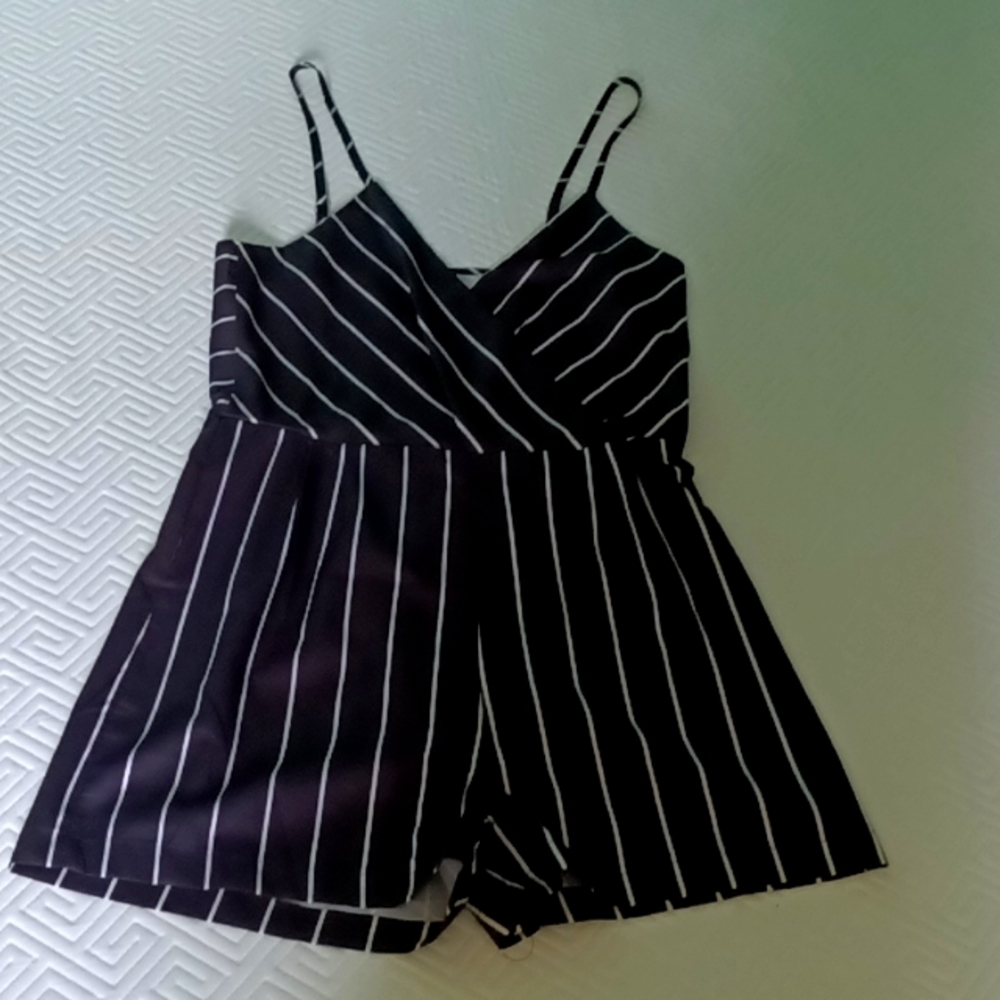 Black romper with white stripes, size medium but fits more like a small